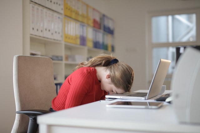 heartbroken lady put head on her laptop